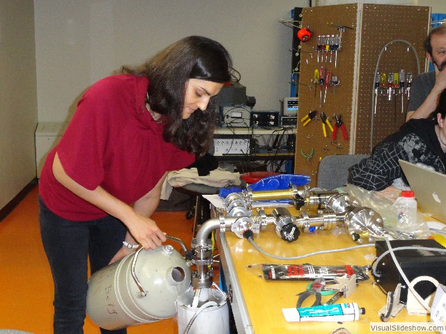 Justine Mesnard fills a cryopump for the gas effusion experiment.