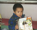 boy displays a book